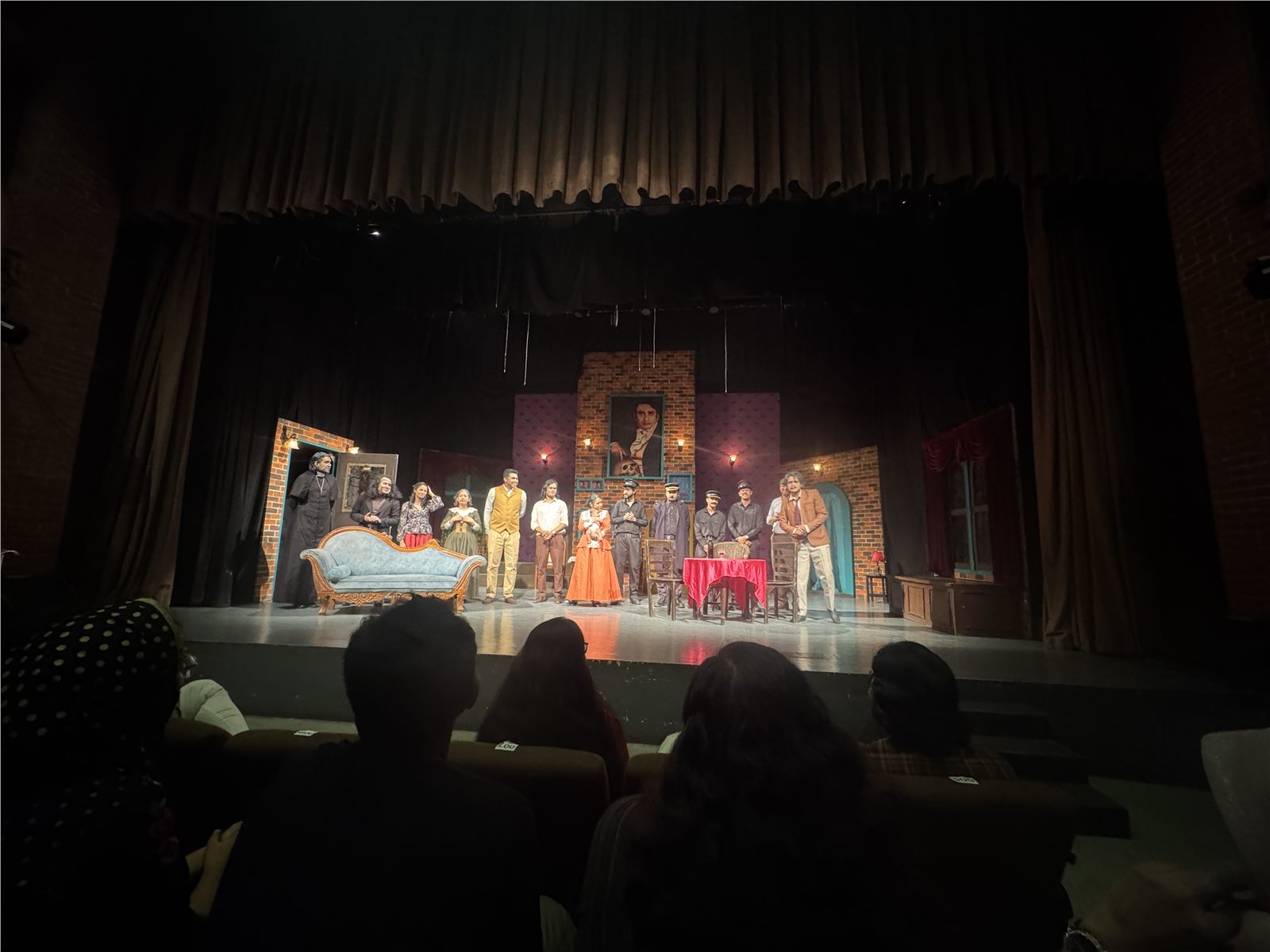 Wide view of the theatre stage during the curtain call