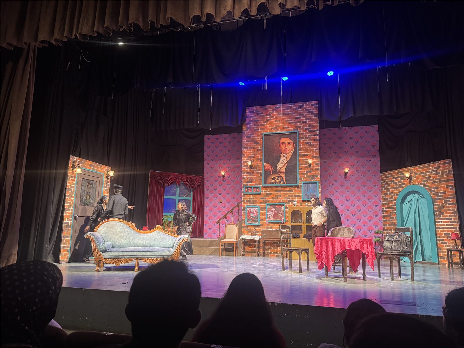 Actors performing on the drawing-room stage set